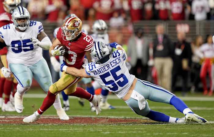 Jan 22, 2023; Santa Clara, California, USA; San Francisco 49ers running back Christian McCaffrey (23) runs past Dallas Cowboys linebacker Leighton Vander Esch (55) during the third quarter of a NFC divisional round game at Levi's Stadium.